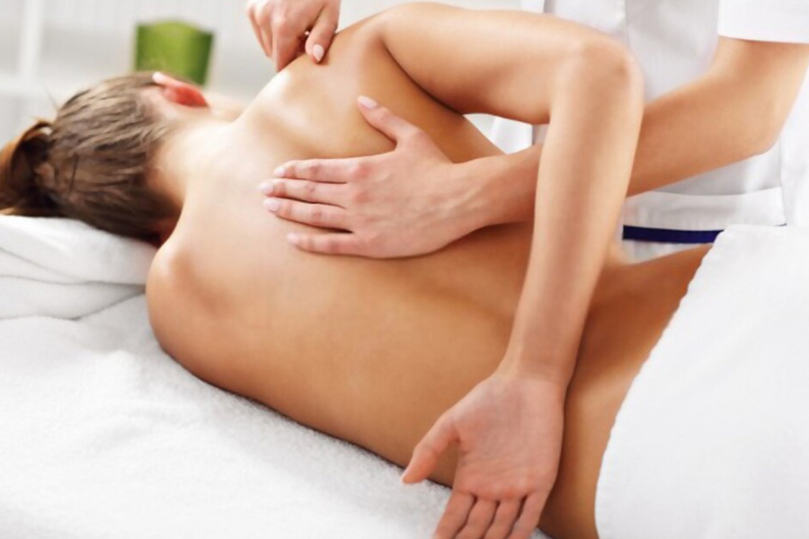 Woman getting a osteothaty massage in therapy room