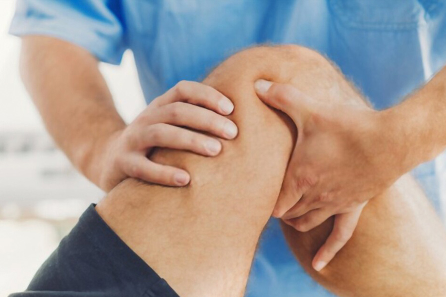 Physiotherapist working examining treating injured arm of athlete patient, stretching and exercise