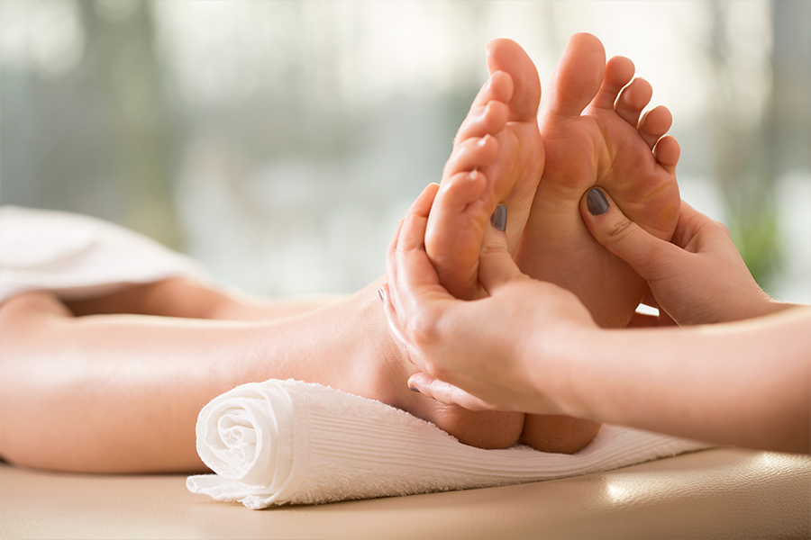 Woman having relexology feet massage