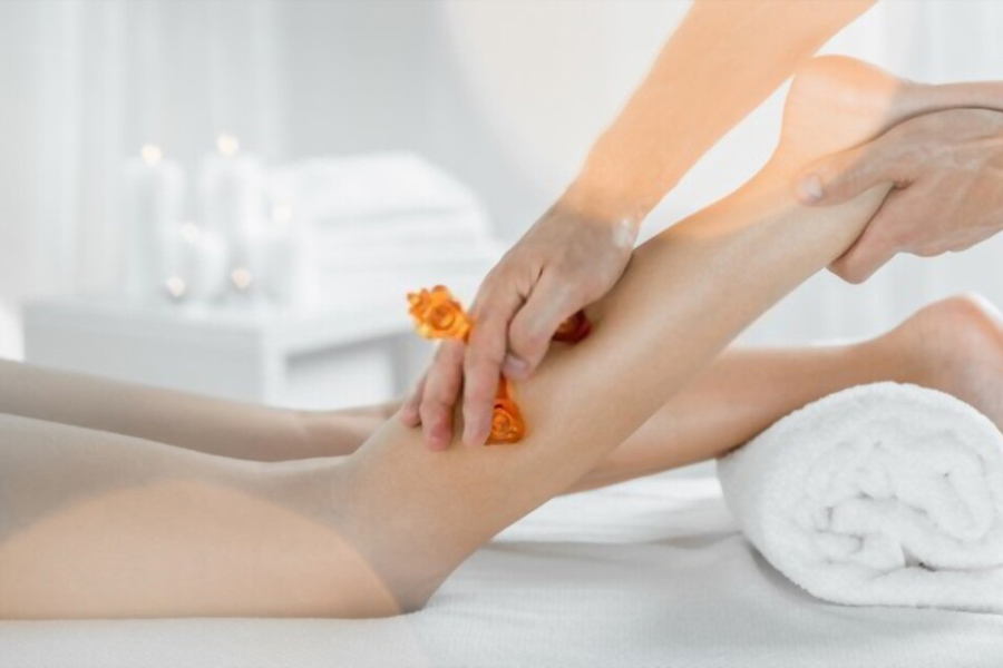 Massager does leg lymphatic drainage massage to woman