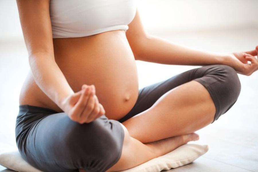 Pregnant woman meditating in Ibiza