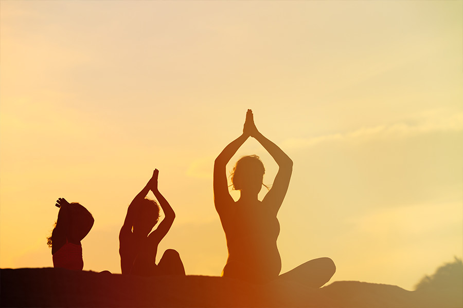 Yoga for children. Woman doing yoga with her child